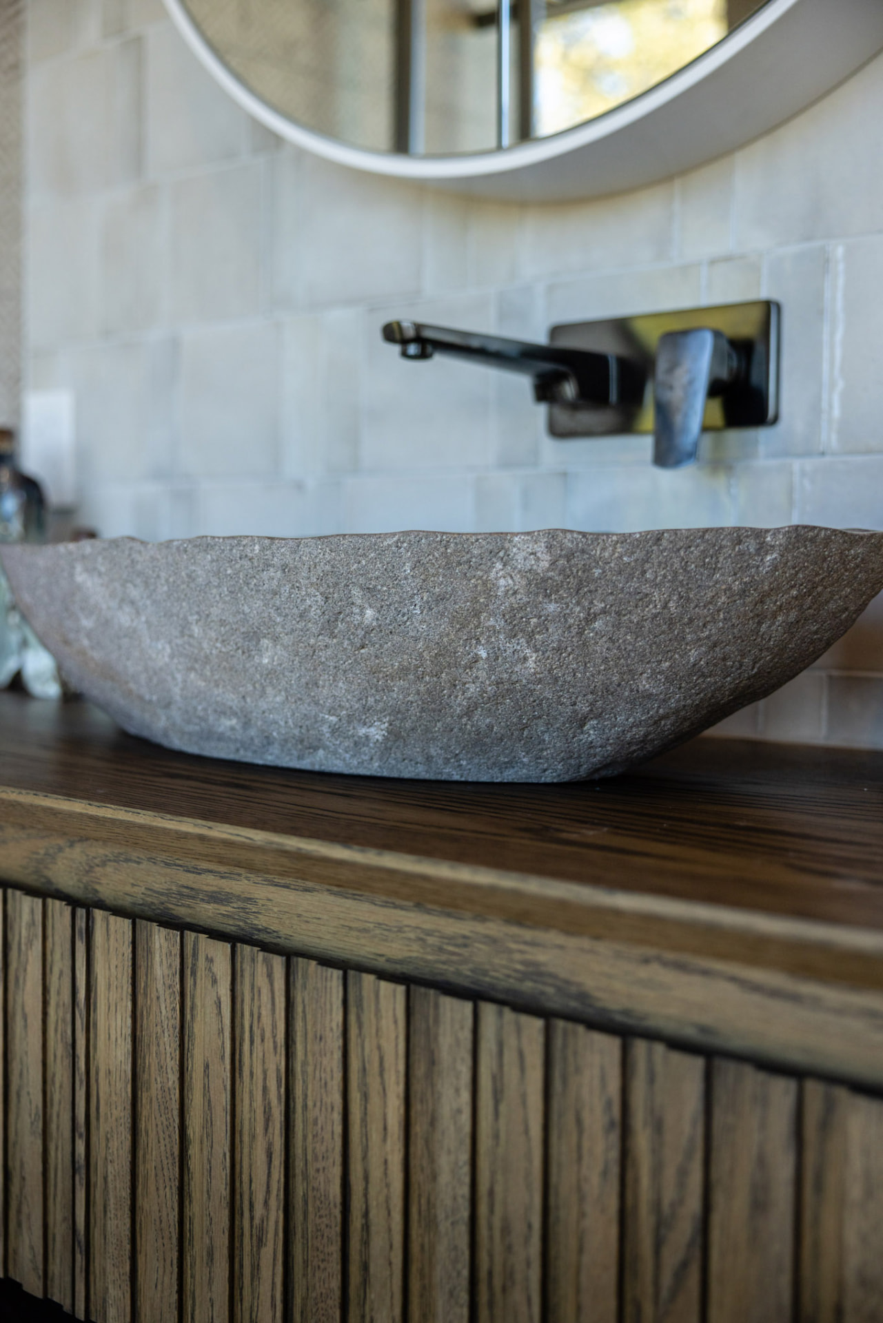 Stone basin in the primary suite ensuite at Whakahā