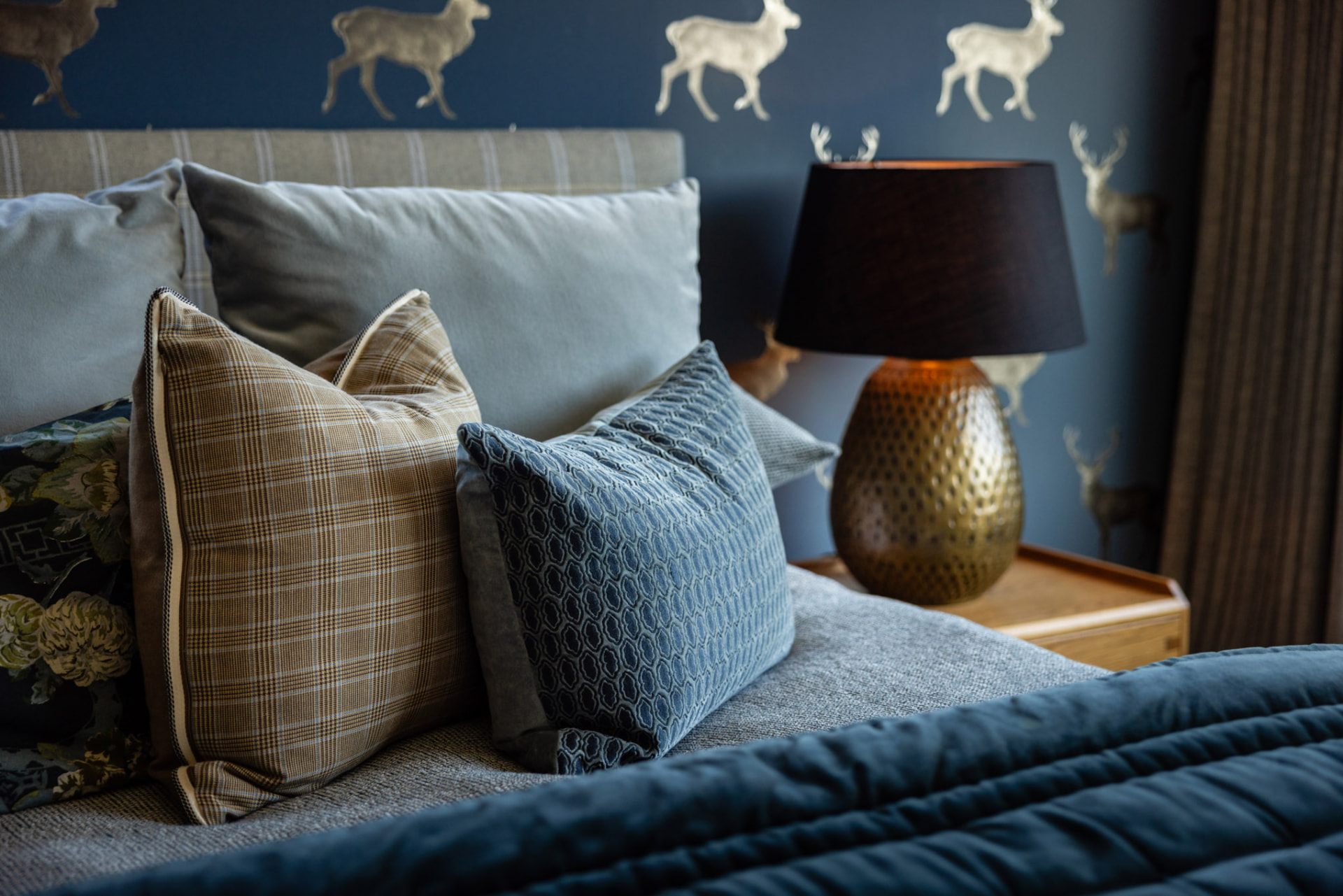 Layered cushions and lamp detail in the second suite at Whakahā