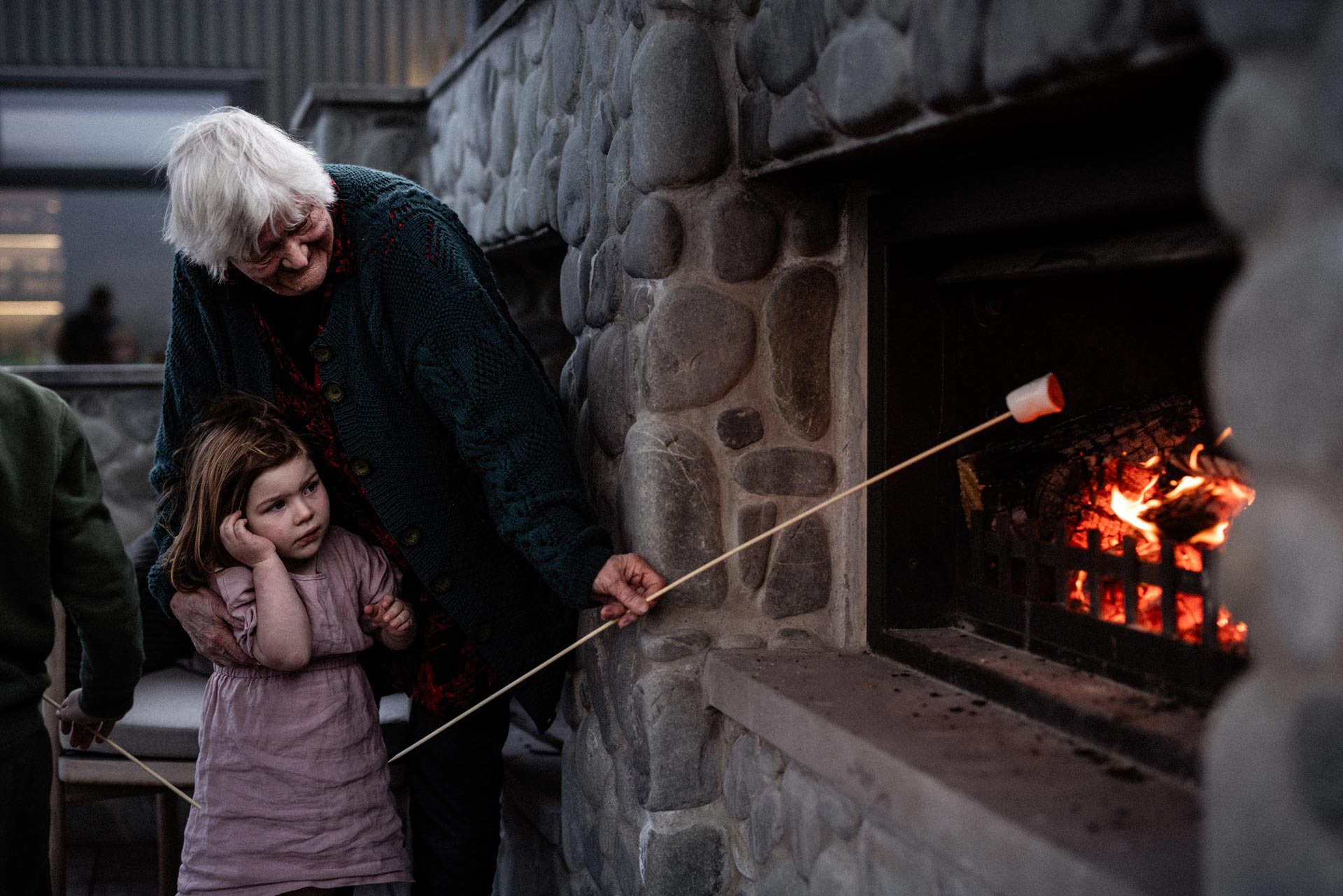 Roasting marshmallows by the stone fireplace at Whakahā