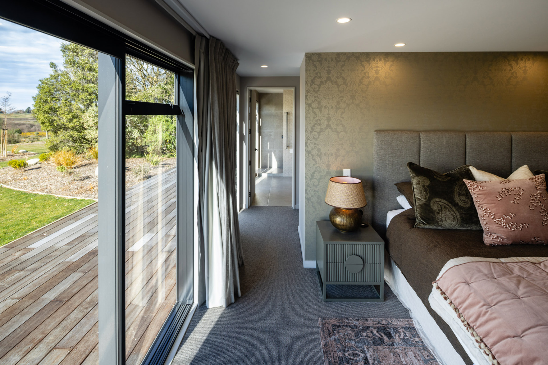 Primary suite looking out to the deck and garden at Whakahā