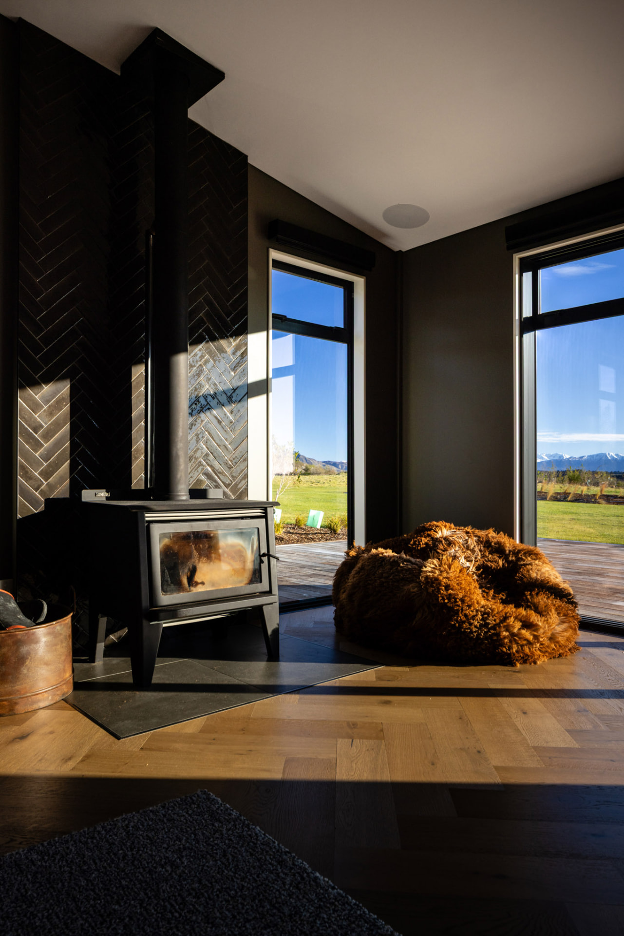 Living area wood fire with mountain views at Whakahā